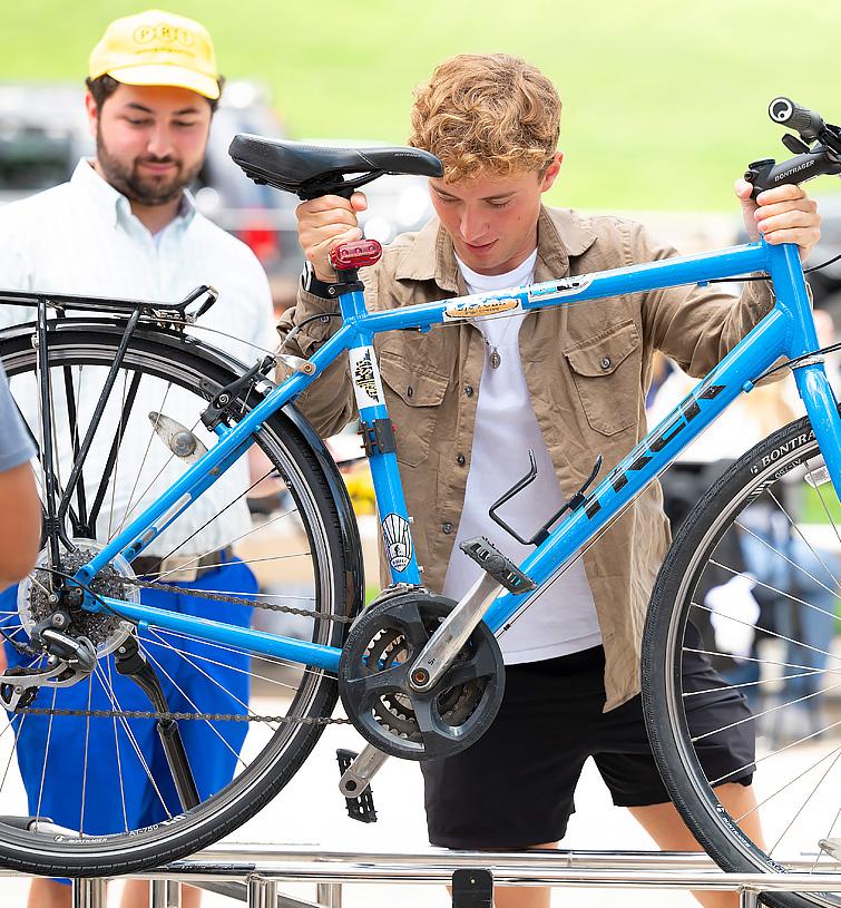 A student checks his bike for safety requirements